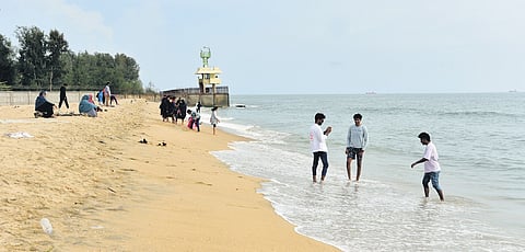 Tourists spend their evening at the at Puthuvype beach on Monday, a day after a group of youngsters were caught in the waves