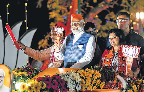 PM Narendra Modi during his roadshow. Bhubaneswar MP candidate Aparajita Sarangi & state president Manmohan Samal are also seen