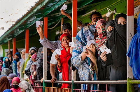 People wait to cast their votes during the sixth phase of Lok Sabha elections, in East Delhi constituency, Saturday, May 25, 2024.