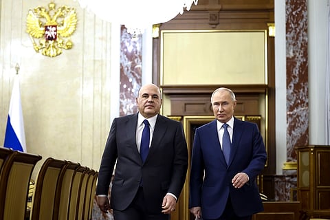 Russian President Vladimir Putin, right, escorted by Russian Prime Minister Mikhail Mishustin arrives for a meeting with Cabinet members in Moscow, Russia, Monday, May 6, 2024.