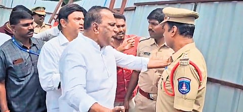 Former minister Ch Malla Reddy and his son-in-law Rajashekar Reddy are seen arguing with the police over a fence on a property they claimed ownership
