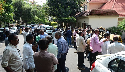 Supporters of MLA H D Revanna in front of the residence of former PM H D Devegowda, where Revanna came to meet his father after his release on bail from Parappana Agrahara, in Bengaluru on Tuesday.