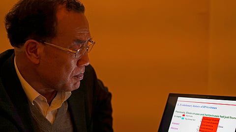 Zhang Yongzhen, the first scientist to publish a sequence of the COVID-19 virus, looks at a presentation on his laptop in a coffeeshop in Shanghai, China.