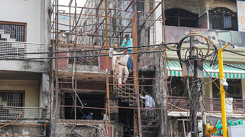 Forensic Science Laboratory team investigates at the site of the fire at the Baby Care Hospital, at Vivek Vihar, in East Delhi, Monday.