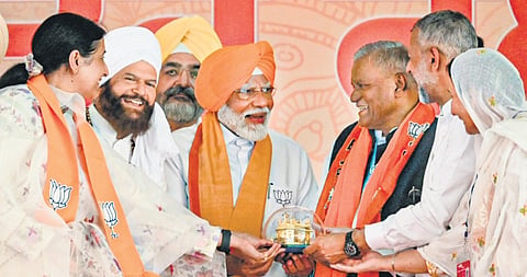 Prime Minister Narendra Modi being felicitated during a public meeting in support of BJP candidate Preneet Kaur for Lok Sabha elections in Patiala on Thursday.