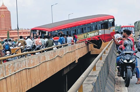 The bus heading to Bengaluru from Somwarpet via Tumakuru, hangs mid-air at Madanaykanahalli flyover on Saturday morning