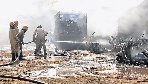 Firefighters douse a blaze that broke out at the Wazirabad police training centre.