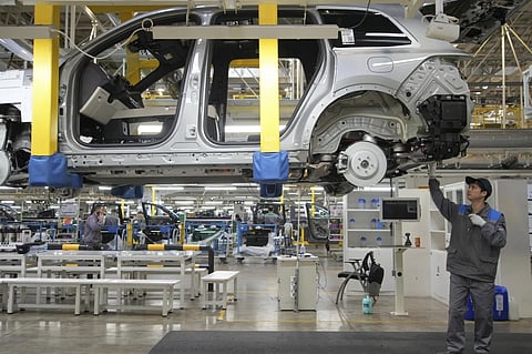A worker assembles an SUV at a car plant of Li Auto, a major Chinese EV maker, in Changzhou in eastern China’s Jiangsu province on March 27, 2024.