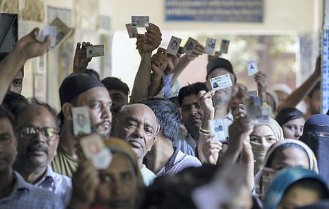 People wait in queues to cast their votes during the sixth phase of Lok Sabha elections, at a polling booth in East Delhi, Saturday, May 25, 2024.