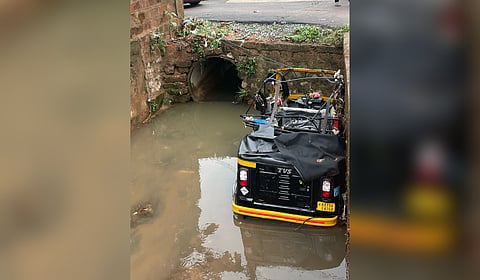 Autorickshaw damaged after falling into an open drain at Kottara in Mangaluru