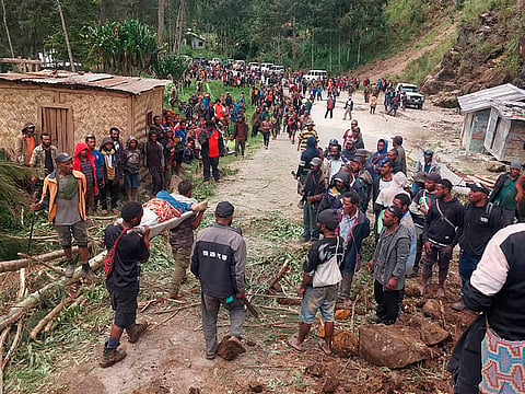 In this photo provided by the International Organization for Migration, an injured person is carried on a stretcher to seek medical assistance .