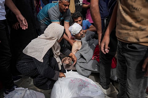 Palestinians mourn relatives killed in the Israeli bombardments of the Gaza Strip in front of the morgue of the Al Aqsa Hospital in Deir al Balah, Gaza Strip, on Saturday, May 11, 2024.