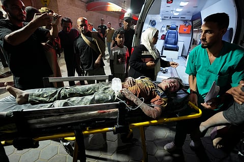 A Palestinian wounded in an Israeli bombardment on the Gaza Strip is brought to Al Aqsa hospital in Deir al Balah, central Gaza Strip, on Sunday, May 26, 2024.