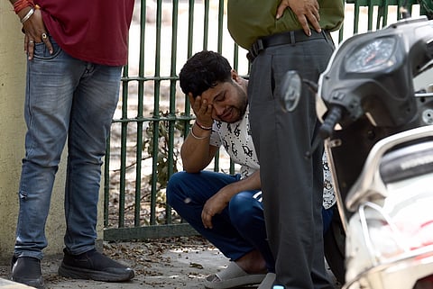 Vinod Kumar, father of one of the newborn babies who were admitted at the Baby Care New Born Hospital after birth, cries after a fire broke out at the hospital on Saturday night, in New Delhi, Sunday, May 26, 2024.