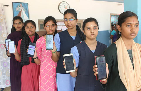 Coimbatore students display their results on their mobile in Coimbatore