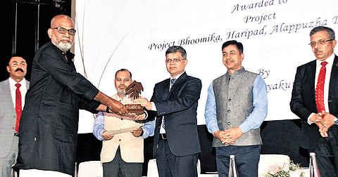 Architect N S Abhayakumar receiving HUDCO design award in the category of cost effective rural/urban housing for project Bhoomika, a flood relief housing initiative