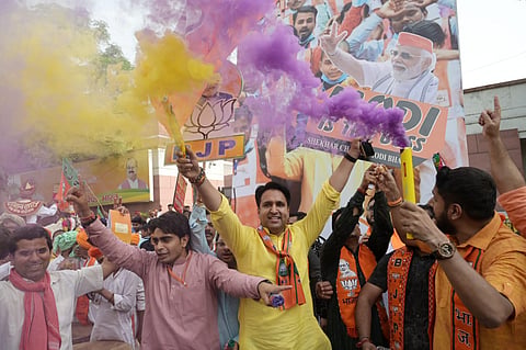 BJP supporters celebrate the party's lead in the Lok Sabha elections at party headquarters as counting of votes underway, in New Delhi