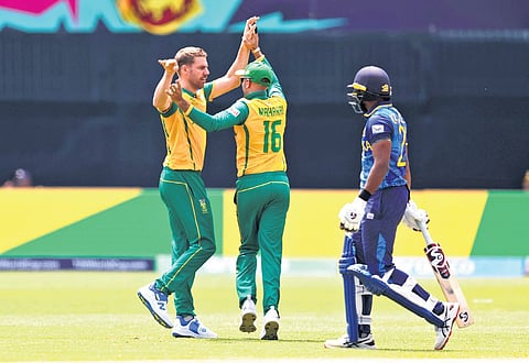 South Africa’s Anrich Nortje celebrates a Sri Lanka wicket with his teammate