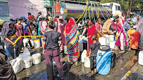 People waiting in long queues and running behind water tankers is a common sight in the city.