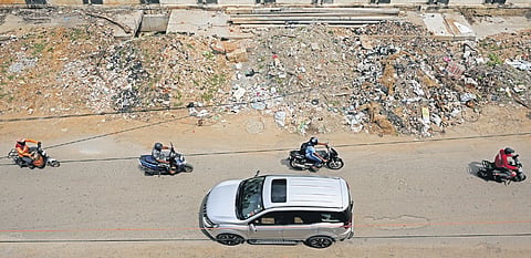 Nearly half of the Shirdi Sai Baba Temple Main Road at Cambridge Layout is blocked with construction waste and garbage