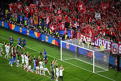 Swiss players greet their supporters at the end of the UEFA Euro 2024 Group A football match between Scotland and Switzerland at the Cologne Stadium in Cologne on June 19, 2024.