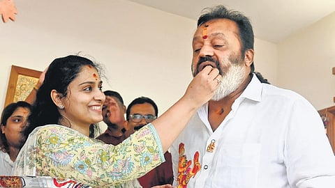 A jubilant Suresh Gopi, who won from the Thrissur Lok Sabha constituency, savours sweets offered by his wife Radhika at their house at Sasthamangalam in Thiruvananthapuram.