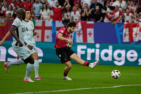 Georgia's Khvicha Kvaratskhelia scores his side's first goal during a Group F match between Georgia and Portugal at the Euro 2024 soccer tournament in Gelsenkirchen, Germany, Wednesday, June 26, 2024.