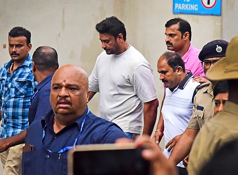 Kannada actor Darshan Thugadeepa (C) being taken to a hospital for a medical checkup, Bengaluru, Tuesday, June 11, 2024.