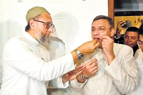 AIMIM chief Asaduddin Owaisi celebrates his victory by offering sweets to his brother Akbaruddin in Hyderabad on Tuesday