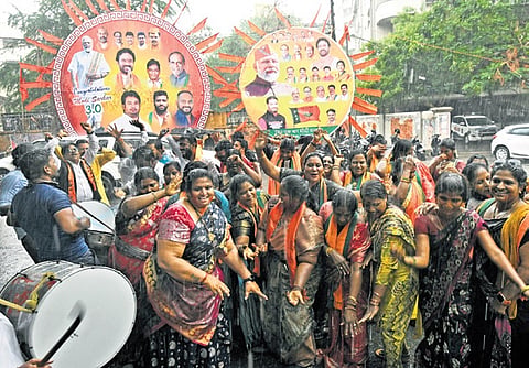 Amidst the rain, cadre celebrate at the BJP office in Hyderabad after the party won eight seats in the state on Tuesday.