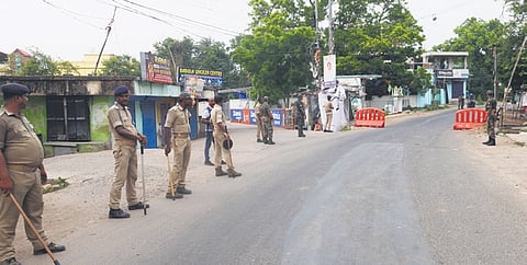 Police personnel stand guard as Balasore town remains under curfew after a clash between two communities, on Tuesday