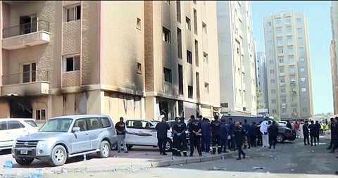 Rescuers arrive at the site of a building that caught fire in Kuwait, Wednesday, June 12, 2024.
