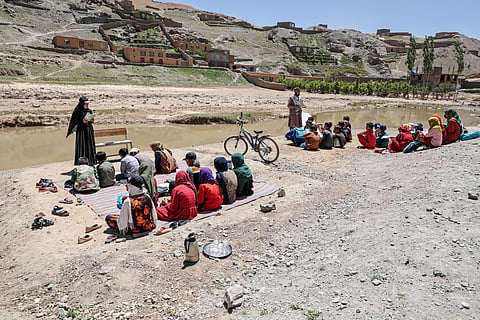 Flash flood affected Afghan children attend an open-air school in Firozkoh of Ghor province on May 30, 2024.