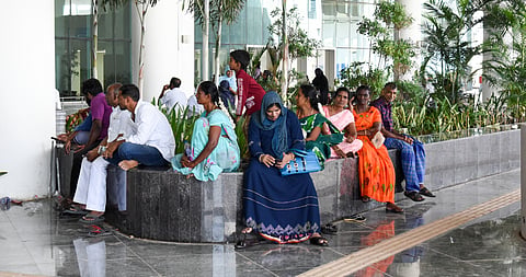 Visitors making do with available spaces at the new terminal in Tiruchy international airport to rest while waiting for the arrival of their loved ones