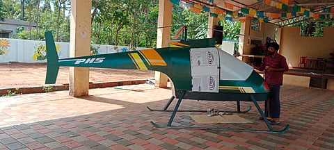 Prabhan with the helicopter he made