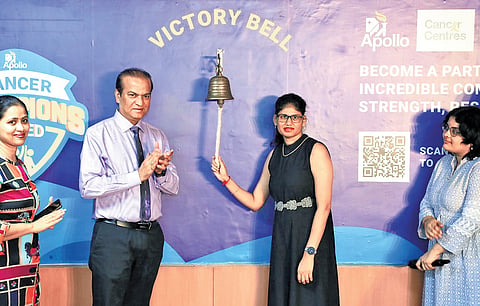 A cancer survivor, flanked by Apollo representatives, rings the ‘victory bell’ at the Apollo Cancer Centre in Hyderabad on Saturday