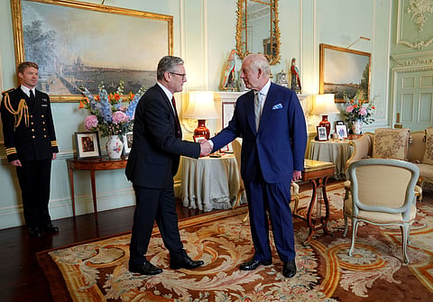 King Charles III shakes hands with Keir Starmer