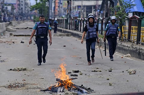 Police patrol the streets during an imposed curfew after scores were killed and hundreds injured in clashes over the allocation of civil service jobs, in Dhaka, Bangladesh, Sunday, July 21, 2024.