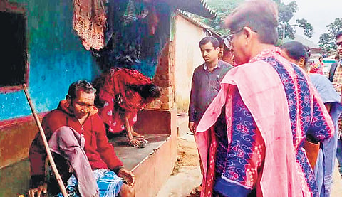 Health officials interacting with a patient in Lambiri village