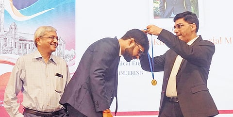 Indian Chess Grandmaster Viswanathan Anand presents a gold medal to a student during the IISc convocation on Monday