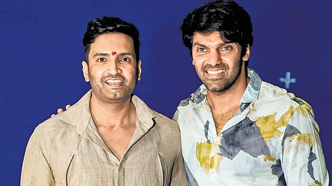 Actors Santhanam and Arya.