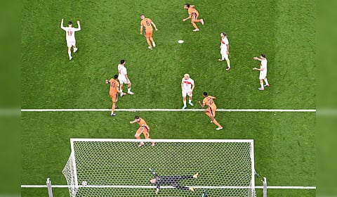 Turkey's goalkeeper Mert Gunok (down) reacts after conceding a goal scored by Netherlands' defender #06 Stefan de Vrij during the UEFA Euro 2024 quarter-final football match between the Netherlands and Turkey on July 6, 2024.