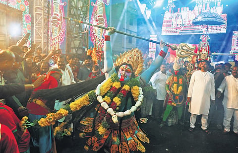Devotees dressed like Hindu deities were seen performing during a Bonalu procession in Old City on Sunday