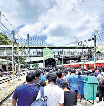 Passengers jostle to make their way through one of the narrow staircases
at KR Puram Railway Station | EXPRESS