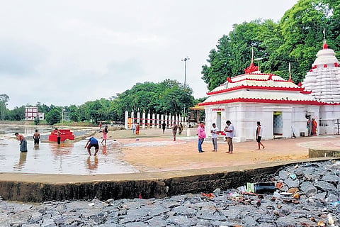 People removing water from the premises of Bhattarika temple