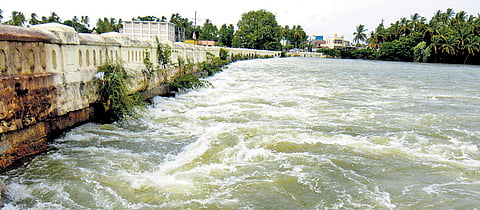 Water flows just under the Wellesley Bridge near Srirangapatna in Mandya district on Saturday after heavy discharge from KRS Dam. The bridge stands at a height of over 20 feet