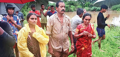 Five stranded persons were rescued after their car was washed away in Eluru district