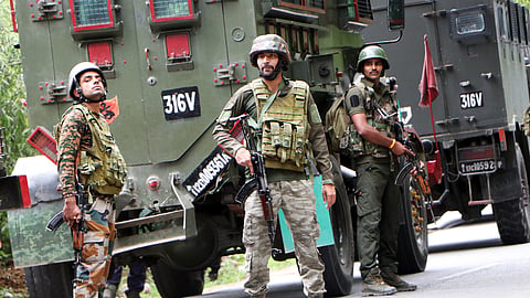 Army personnel stand guard at the encounter site where a jawan was killed in a gunfight with terrorists, in Kulgam on Saturday.