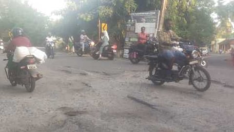 The heavily damaged portion of road at the west end of Anaipalam railway over bridge at Edalakudy on Kaliyakkavilai -Kanniyakumari NH road.