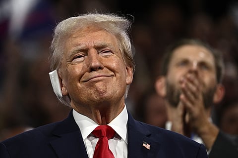 US former President Donald Trump, a bandage on his ear after being wounded in an assassination attempt, attends the first day of the 2024 Republican National Convention.